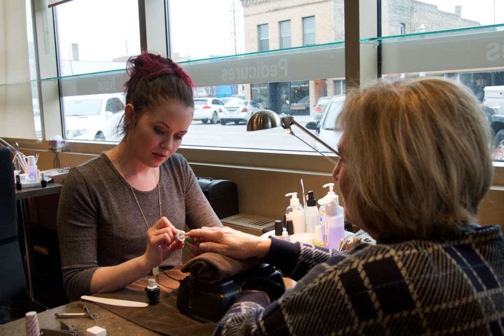 Val Halverson, right, comes to Nail Bar every other week so her favorite manicurist, Karissa Geiger, can do her nails. (Photograph by Mattie Hanson)